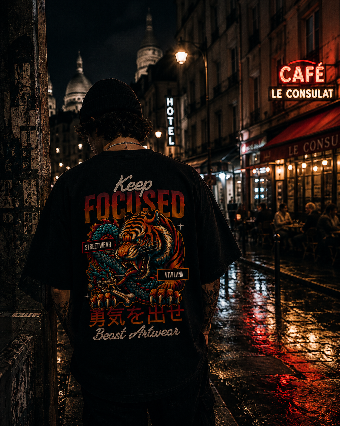 Man wearing black streetwear t-shirt with tiger and dragon art, 'Keep Focused' text, Paris night scene