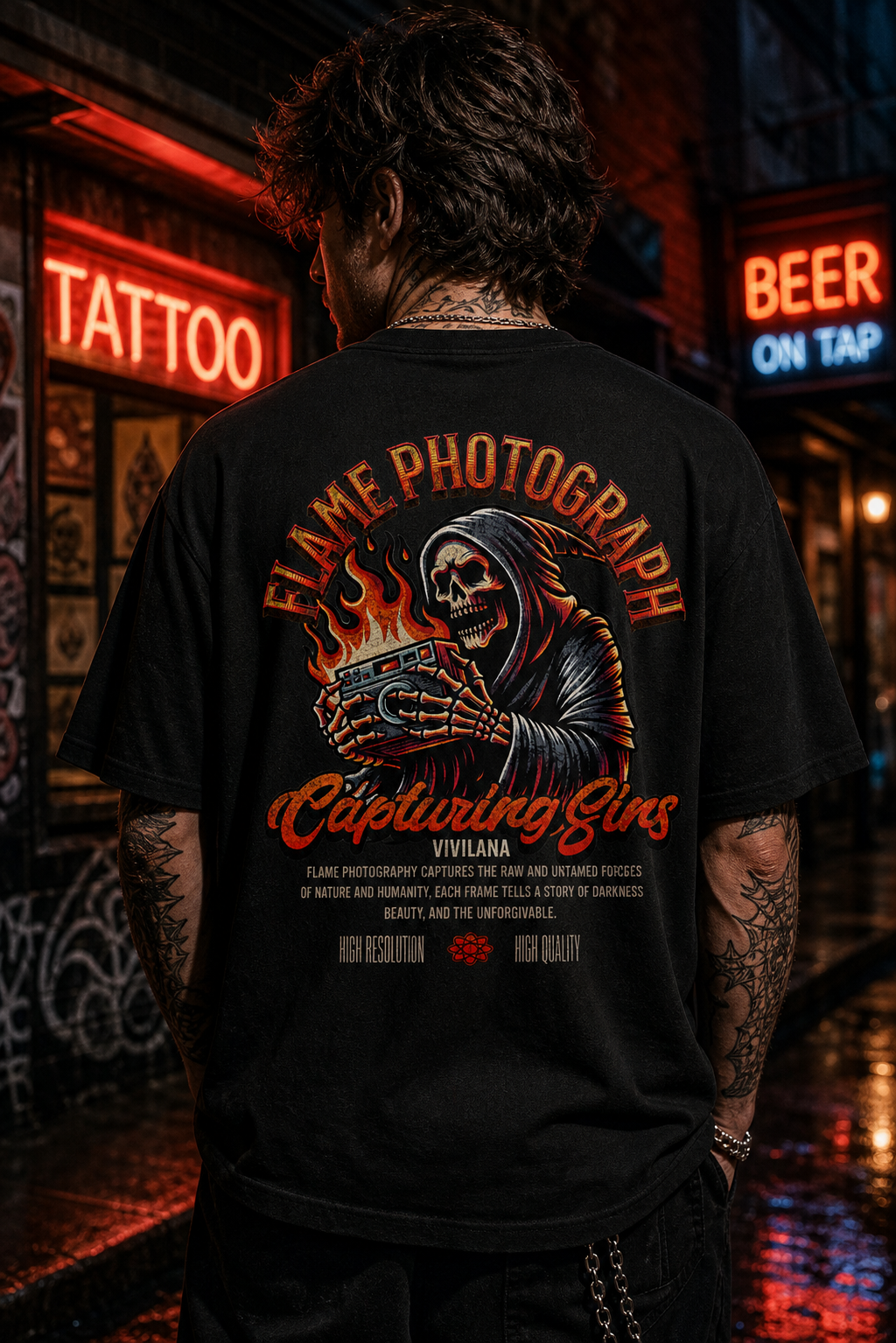 Black graphic tee with skull holding camera, 'Flame Photography' text, worn on street at night near neon signs