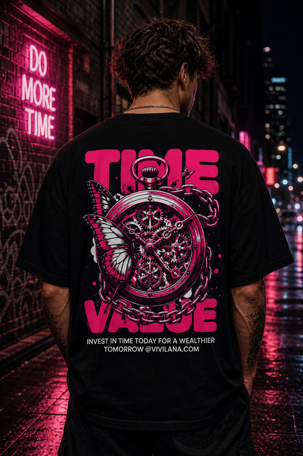 Black graphic tee with pink 'TIME VALUE' text, pocket watch, and butterfly design, worn on city street at night