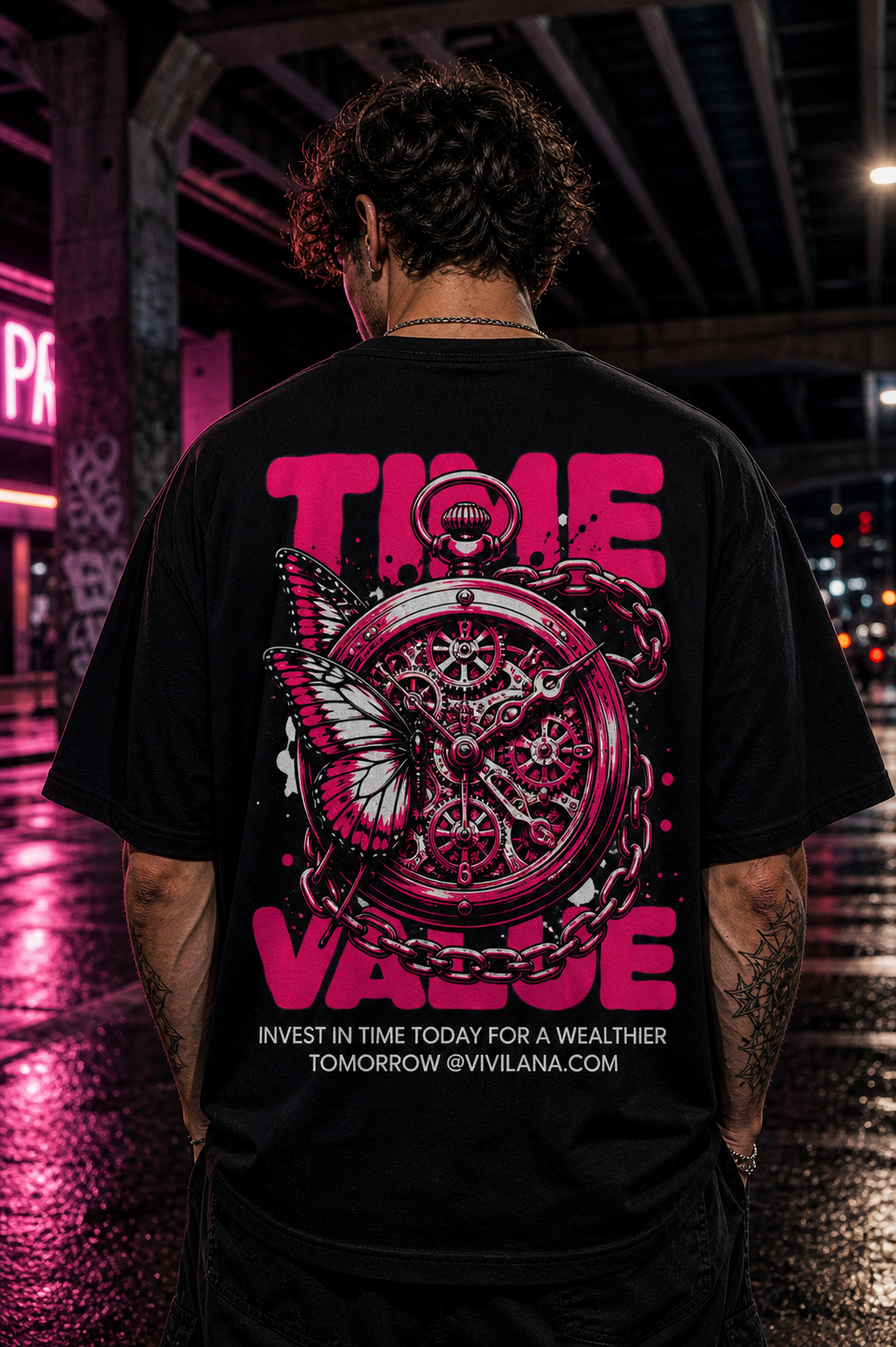 Black t-shirt with pink 'TIME VALUE' graphic, pocket watch, butterfly, and chain design on urban street