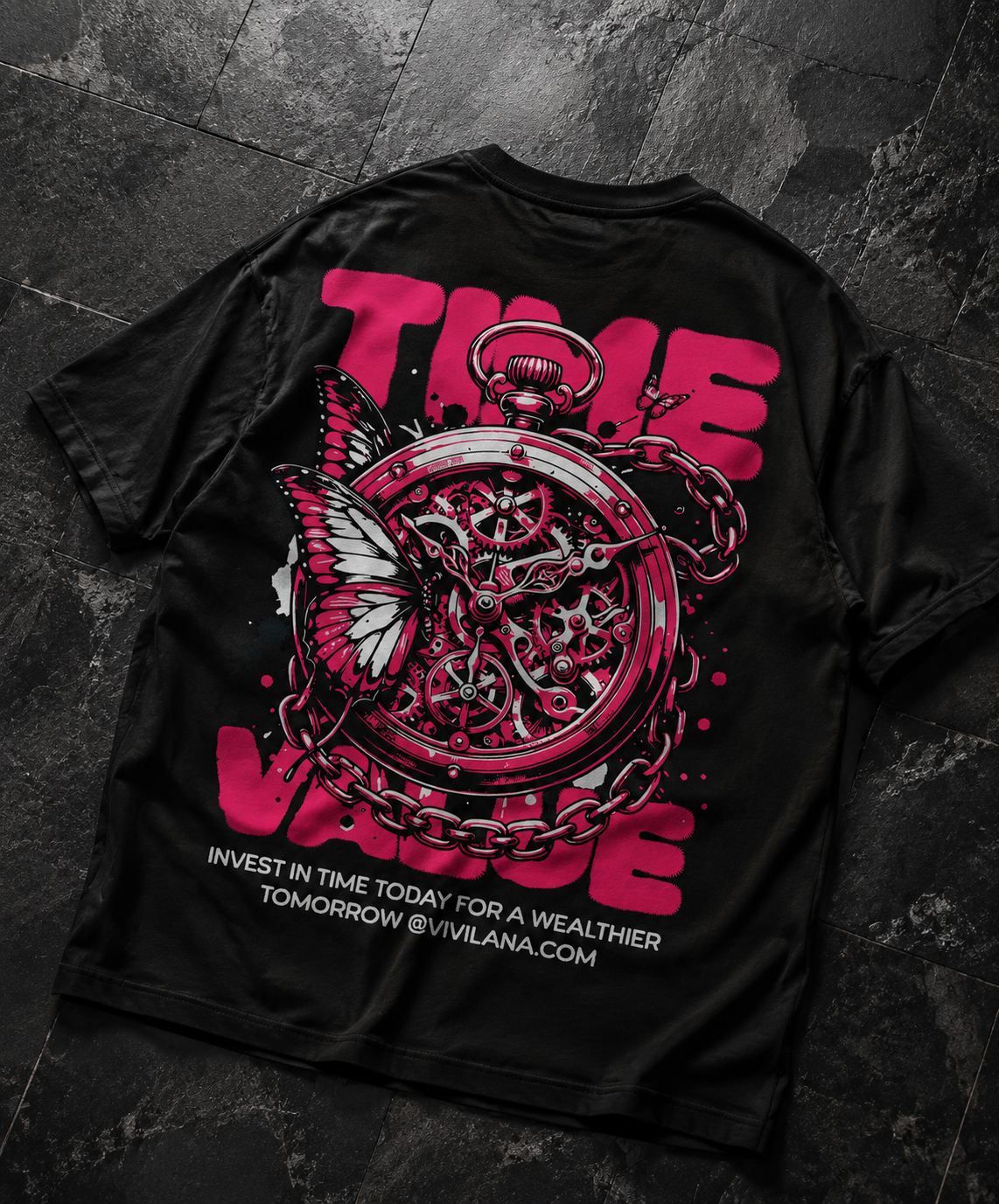 Black graphic tee with pink 'TIME VALUE' text, pocket watch, butterfly, and chain design on dark tile