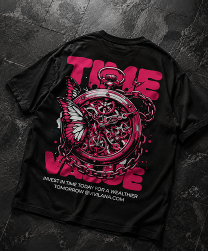 Black graphic tee with pink 'TIME VALUE' text, pocket watch, butterfly, and chain design on dark tile
