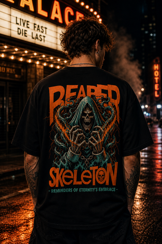 Man wearing black graphic tee with grim reaper skeleton design, 'Reaper Skeleton' text, urban night street backdrop