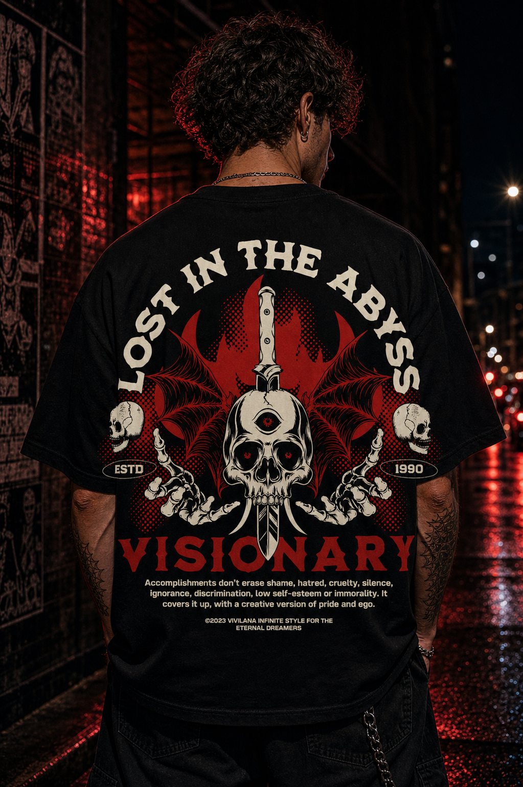 Black graphic tee with skull, wings, and 'Lost in the Abyss Visionary' text, urban night setting